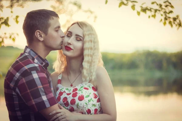 a guy with a girl, a couple in love, before a kiss, at sunset