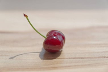 Tek Kiraz ahşap arka plan üzerinde Kapat