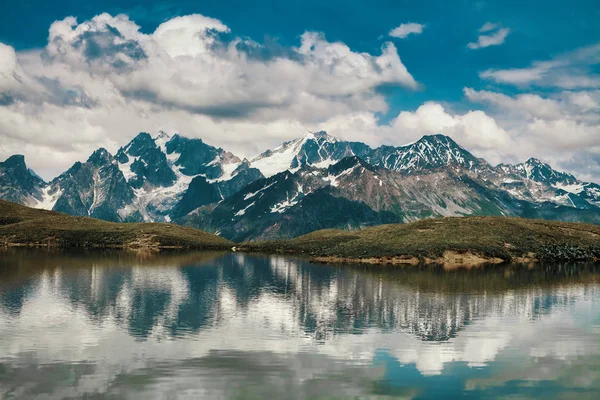 Mountains reflected in the lake. Beautiful landscape. Lake Koruldi, region Mestia, Georgia. Caucasian ridge.