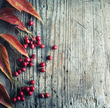 ahşap arka plan üzerinde yerleştirilen çilek ile yukarıdan Sonbahar yaprakları