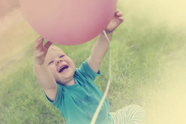 Mały Chłopiec Bawi Różowy Balon Lato Łąka — Zdjęcie stockowe
