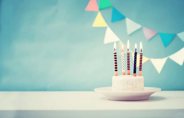 Birthday cake with candles in vintage colors, copy space