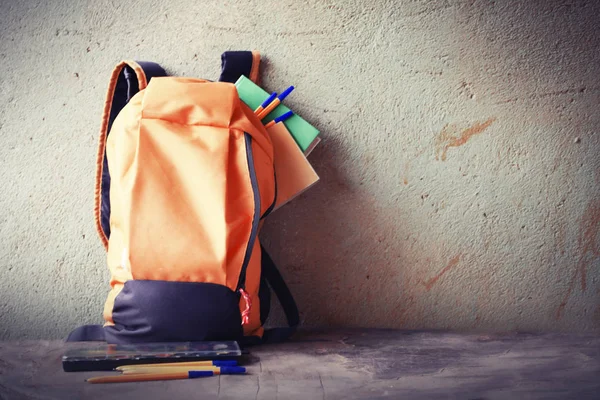 closeup view of schoolbag against rustic wall