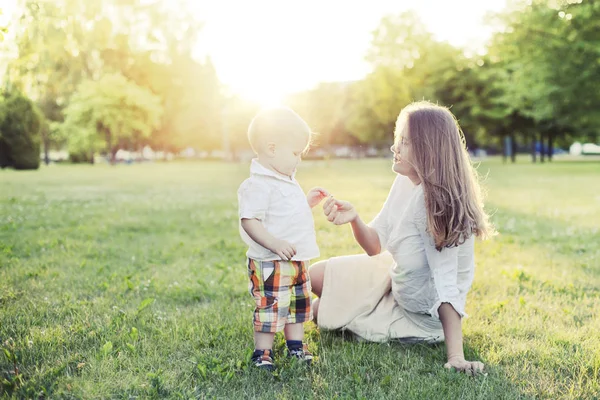 Happy Mother Little Son Resting Green Grass Sunny Park — Stock Photo, Image