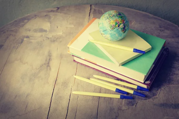 closeup view of globe and books over wooden table