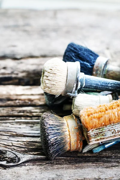 closeup view of different brushes over wooden table