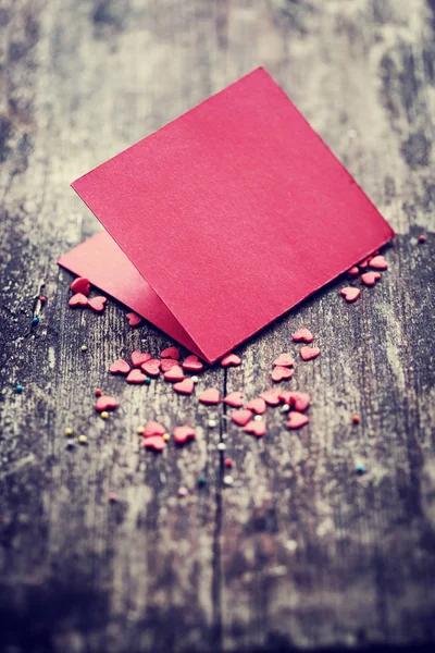 Colorful romantic hearts with red template on wooden background