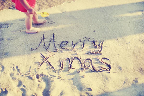 Merry Christmas Written Wet Sand Little Baby — Stock Photo, Image