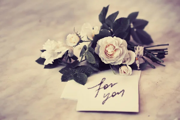 bouquet of fresh roses on love you card