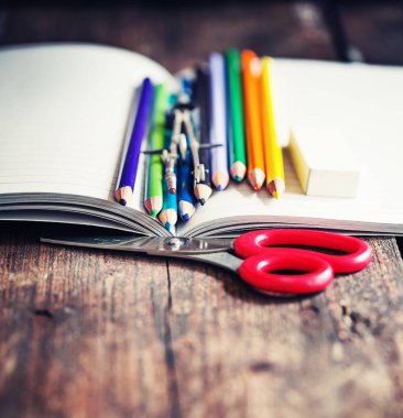 çeşitli çok renkli çizim öğeleri ve yıpranmış ahşap arka plan için makaslar