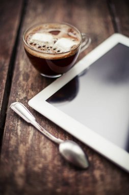 cam fincan sıcak espresso hatmi ve ahşap yüzey üzerinde dijital tablet ile