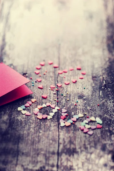 Colorful romantic hearts with red template on wooden background