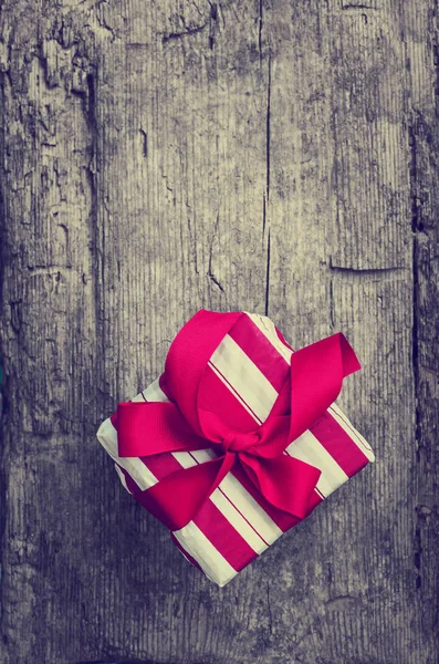 Closeup View Wrapped Christmas Gift Red Ribbon Wooden Background — Stock Photo, Image