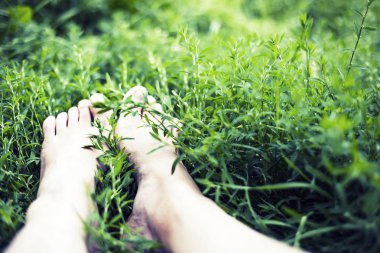 Ayaklarda papatya çiçekler ile çayır çim