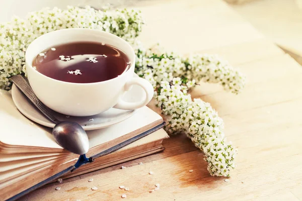 closeup view of fresh tea cup with books