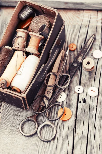 Vintage sewing tools on wooden table