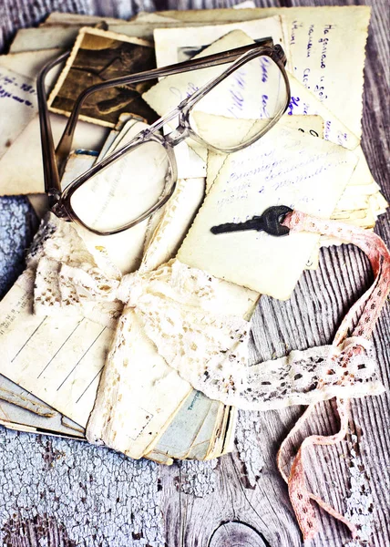 vintage grungy papers with elegant lace ribbon, glasses and key