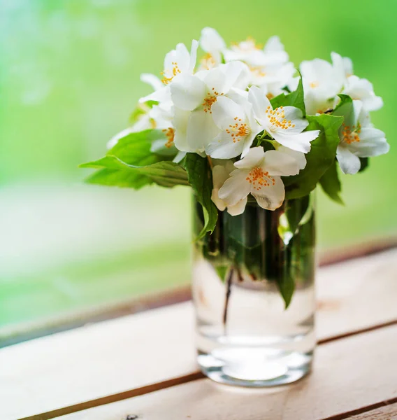 bouquet of white daffodils in vase on windowsill