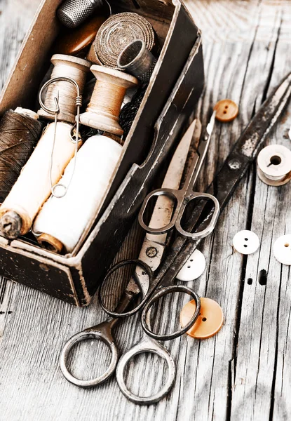 Vintage sewing tools on wooden table