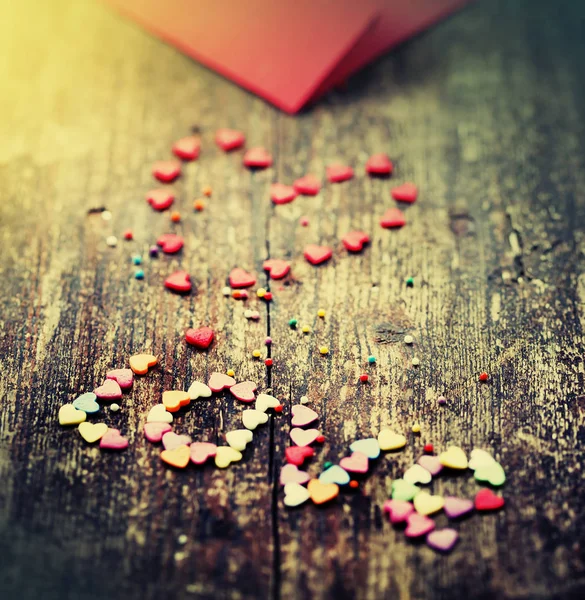 Colorful romantic hearts with red template on wooden background