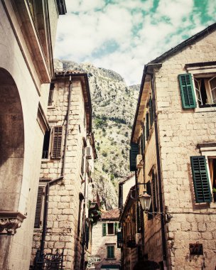 eski tuğla binalar büyük yeşil dağ yakınındaki açık pencereleri ile