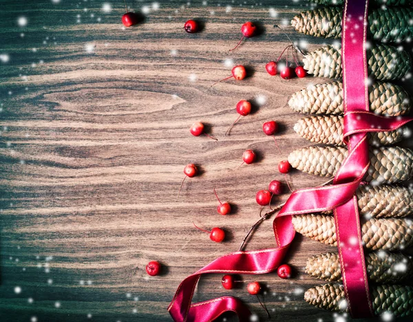 Festive Winter Background Ribbon Berries Cones Wooden Surface — Stock Photo, Image