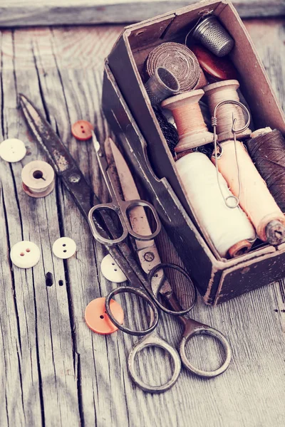 Vintage sewing tools on wooden table