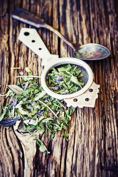 closeup view of dry tea herbs over wooden background