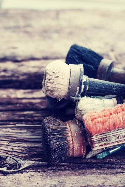 closeup view of different brushes over wooden table