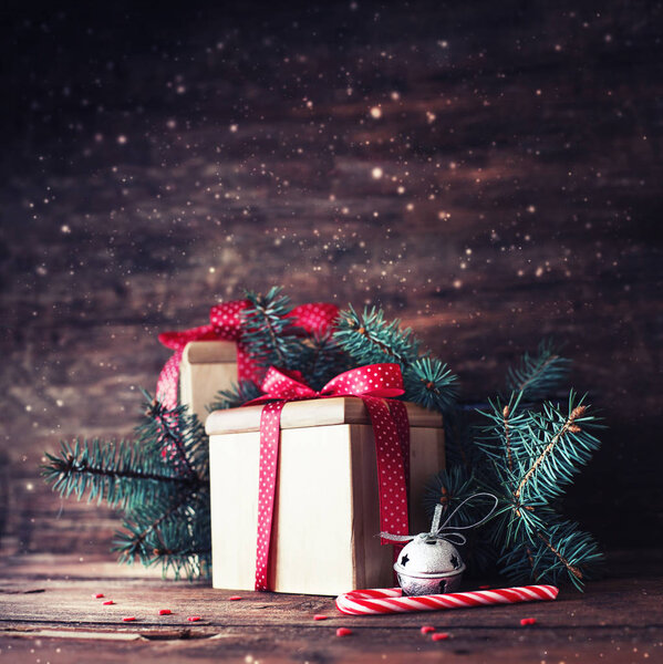 closeup view of wrapped christmas gifts with holiday decorations on wooden background