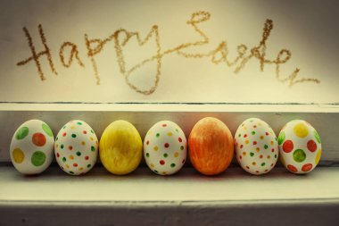 pencere pervazına portre görünümünde renkli boyalı Paskalya yumurta 