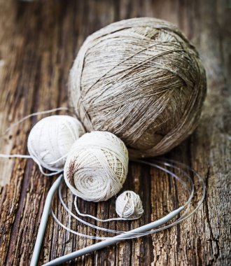 Renkli konu ve örgü iğneleri ahşap arka plan üzerinde