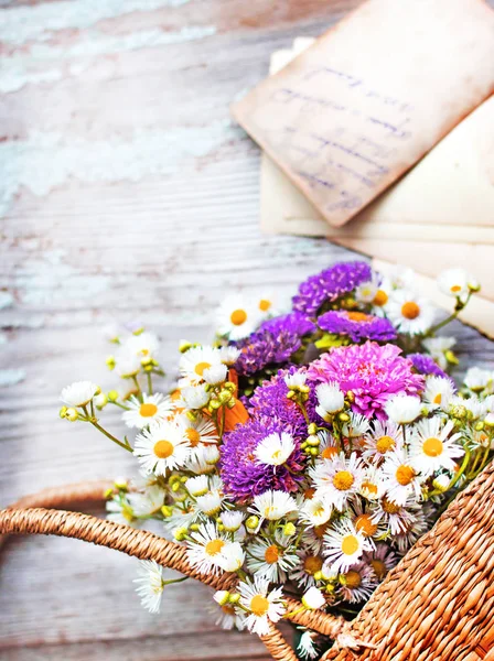 木製の表面の上のバスケットに自然の野の花ブーケのクローズ アップ ビュー — ストック写真