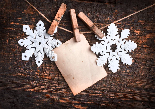 木製のテーブルの上の空白の招待カードと雪の結晶クリスマス背景の平面図 — ストック写真