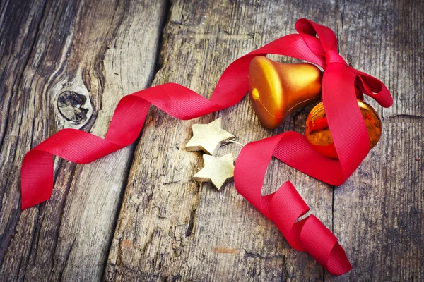 Christmas Bells Red Ribbon Wooden Surface — Stock Photo, Image