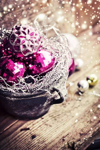 glossing christmas ornaments in bowl on wooden surface