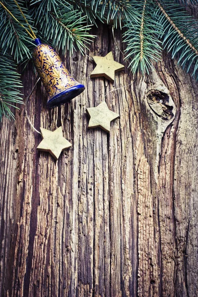 Christmas Bell Stars Fir Branches Wooden Surface — Stock Photo, Image