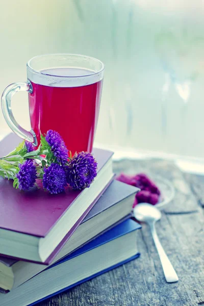closeup view of fresh tea cup with books