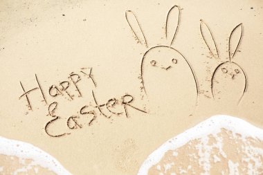 El ile tebrik happy Easter bunnies ıslak kum deniz arka planda yazılı çizilmiş 