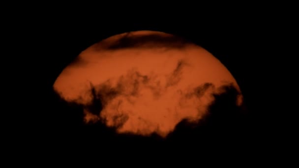 Closeup of huge orange sun with clouds — Stock Video