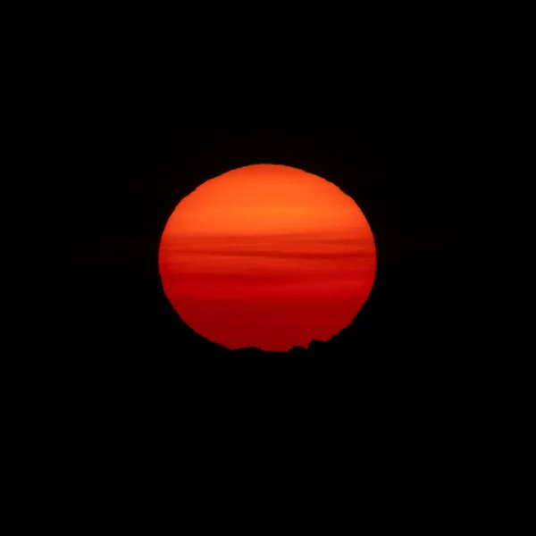 Sunrise over mountain peak with huge orange sun — Stock Photo, Image