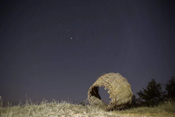 Old wicker basket with startrail in the background — Stock Photo, Image