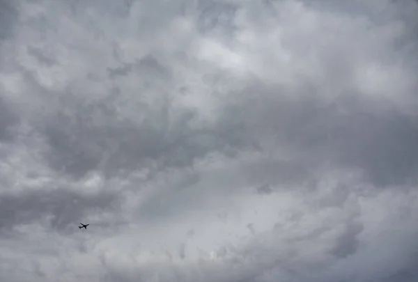 Small jet plane against huge cloudy sky — Stock Photo, Image