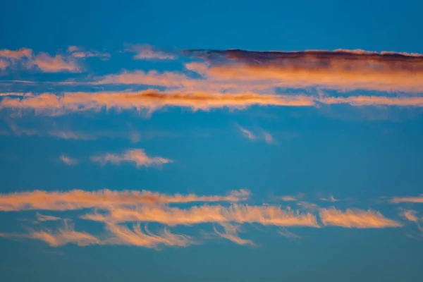 Nuvens laranja e céu azulado ao entardecer — Fotografia de Stock