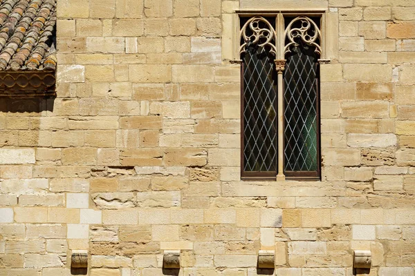 Fondo con ventana antigua sobre pared de piedra fuerte — Foto de Stock