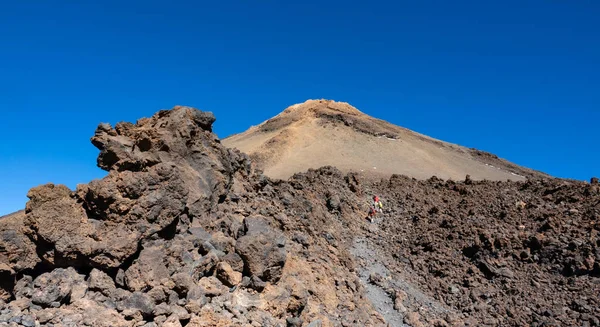 Turisté se propějí na sopečný kráter Teide pod modrým nebem — Stock fotografie