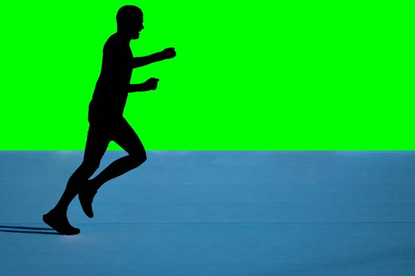 Fast marathon runner silhouette with green background