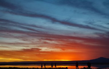 Turuncu gökyüzü ve turistler ile salar gün batımı