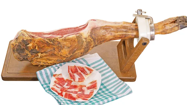 Whole Serrano ham leg with plate and tablecloth — Stock Photo, Image