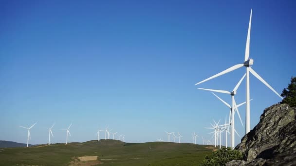 Wind turbines at top of the mountain, blue sky — Stock Video